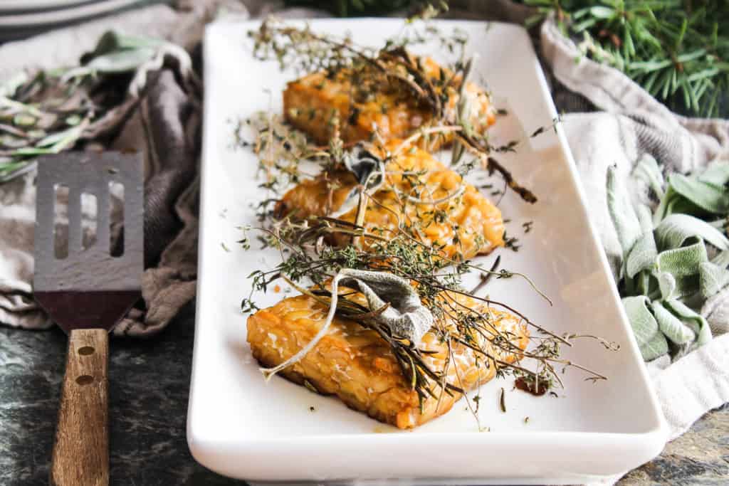 This simple recipe for herb baked tempeh is a flavorful entree that’s wholly worthy of a coveted spot on your holiday table. Plant-based holiday recipe!