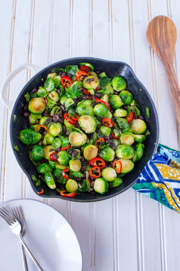 This plant-based main dish or side features Brussels Sprouts, Chili Peppers, and Black Beans. Found on The Grateful Grazer.