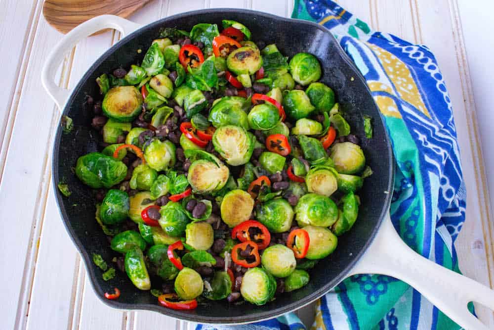 This plant-based main dish or side features Brussels Sprouts, Chili Peppers, and Black Beans. Found on The Grateful Grazer.