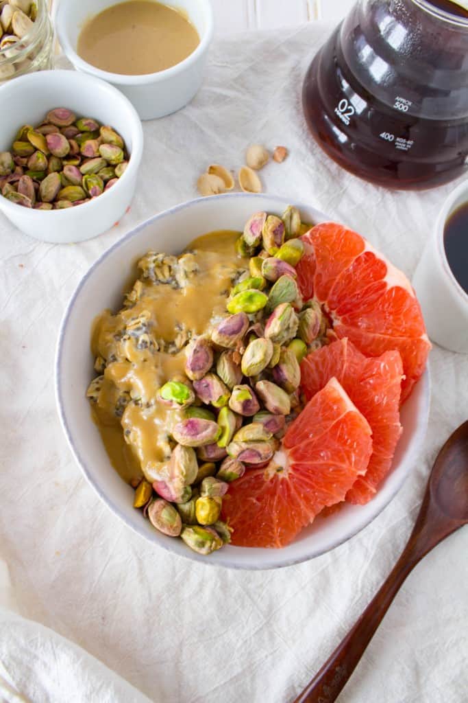 Breakfast Oatmeal Bowl with Grapefruit, Pistachios, + Sweet Tahini Drizzle. A vegan and gluten free healthy breakfast recipe from The Grateful Grazer.