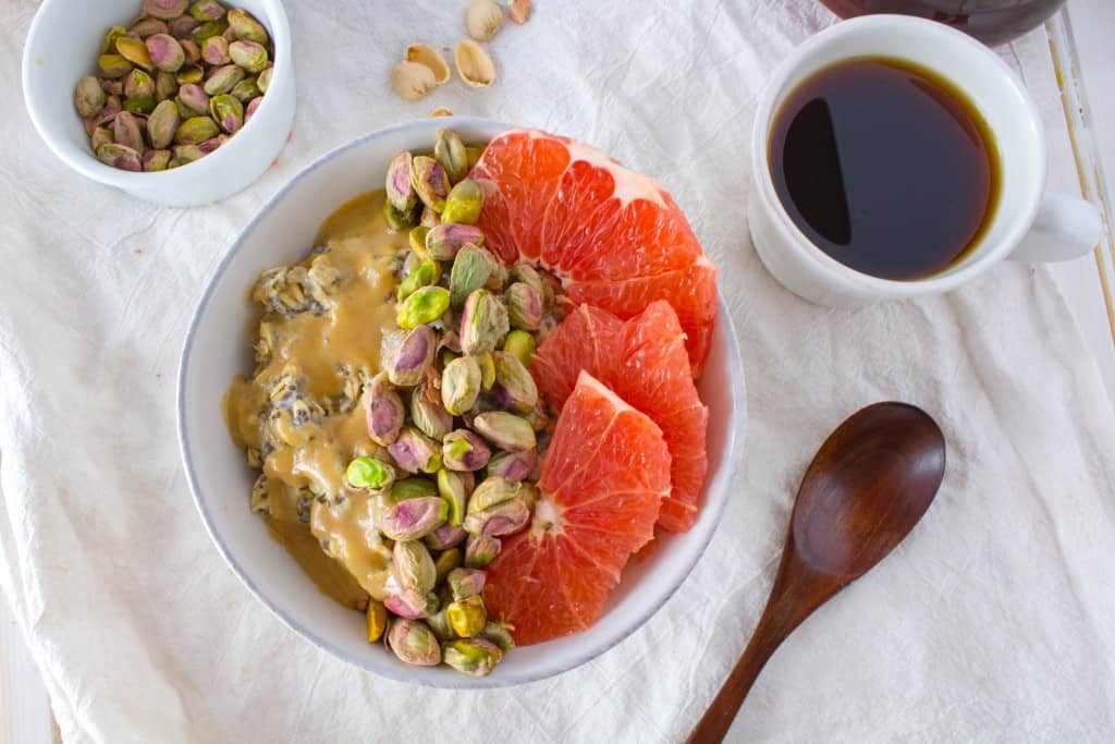 Breakfast Oatmeal Bowl with Grapefruit, Pistachios, + Sweet Tahini Drizzle. A vegan and gluten free healthy breakfast recipe from The Grateful Grazer.