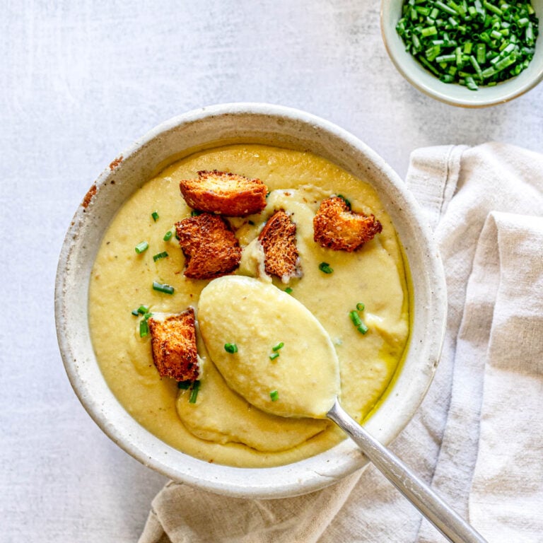 Vegan potato leek soup topped with fresh chives and croutons.