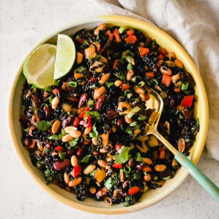 Overhead image of a rice salad with forbidden black rice, beans, and mango.