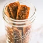 Spicy dried tofu jerky in a glass jar.