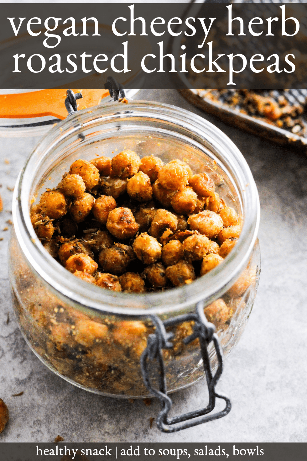 Vegan cheesy herb roasted chickpeas in mason jar against grey background. Title text reads, "vegan cheesy herb roasted chickpeas."