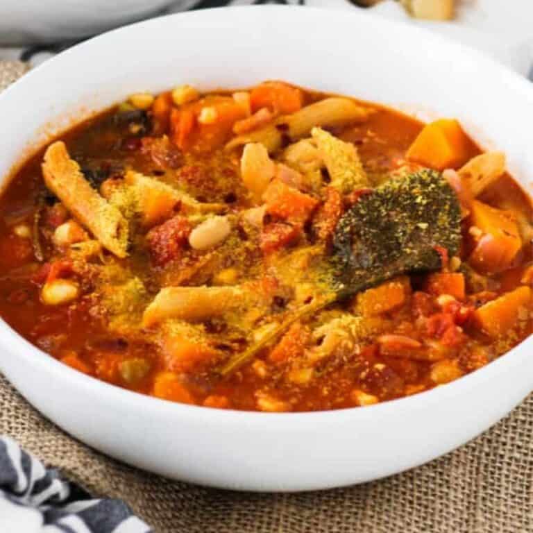Vegetarian butternut squash minestrone soup with pasta and kale.