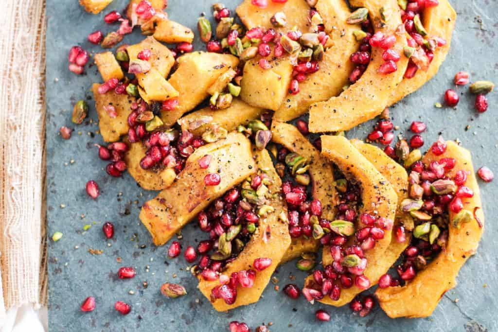 Roasted Acorn Squash with Pomegranate and Pistachios! A simple and delicious Thanksgiving side dish. Recipe via www.gratefulgrazer.com