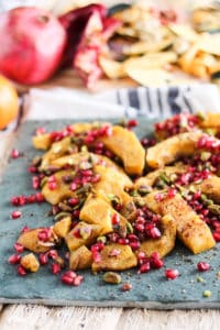 Roasted Acorn Squash with Pomegranate and Pistachios! A simple and delicious Thanksgiving side dish. Recipe via www.gratefulgrazer.com