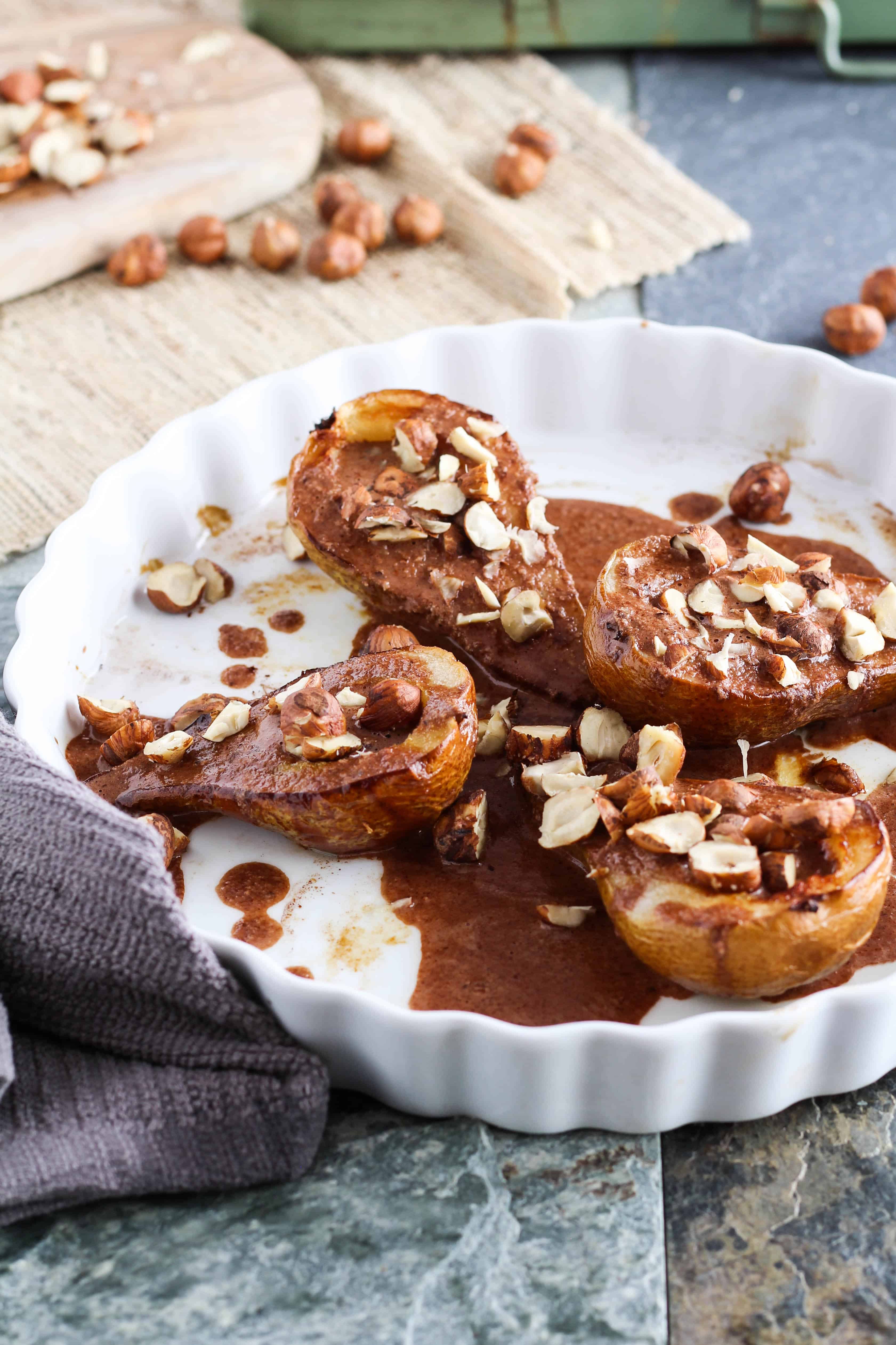 Baked Pears with Dark Chocolate Hazelnut Sauce - a delicious vegan dessert for fall. Recipe from www.gratefulgrazer.com