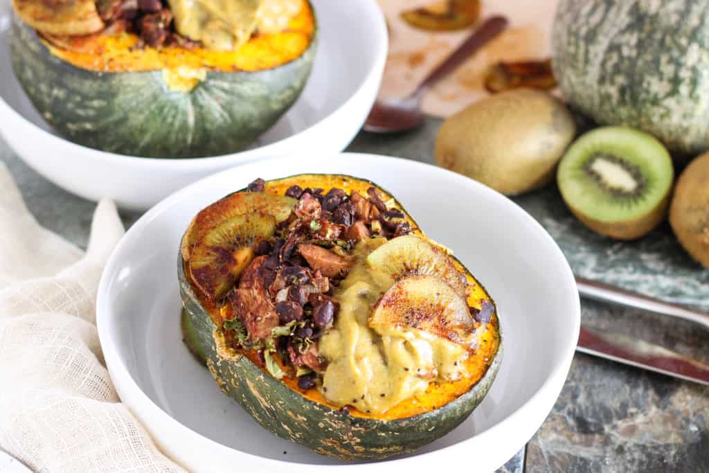 This vegan BBQ jackfruit recipe is perfect for fall/winter! Jackfruit & black beans are served in roasted kabocha squash bowls with creamy kiwi lime sauce. 