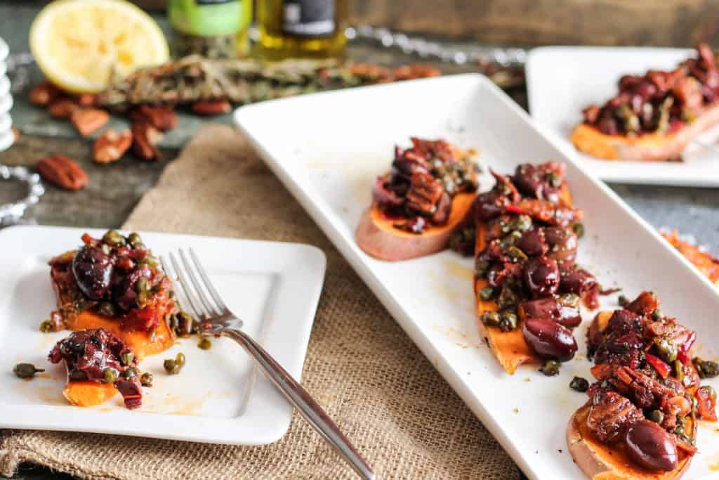 Sweet potato toast topped with a savory tapenade of olives, capers, garlic, and fresh herbs. Healthy holiday party appetizer! Vegan, Gluten-Free.