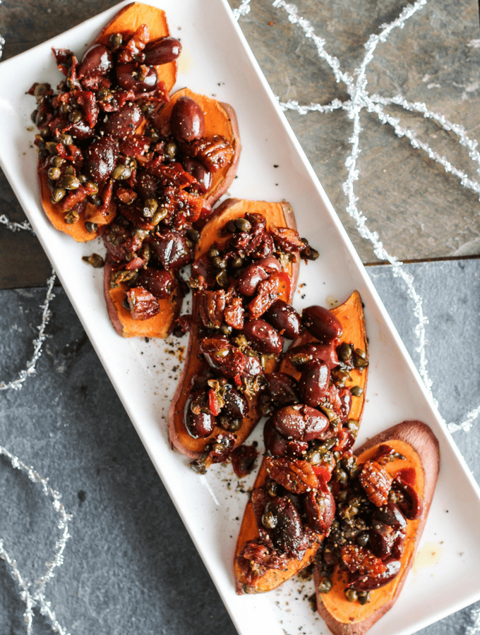 Sweet potato toast topped with a savory tapenade of olives, capers, garlic, and fresh herbs. Healthy holiday party appetizer! Vegan, Gluten-Free.