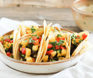 #ad Add a little zest to your summer meals with healthy Black Bean Street Tacos topped with Tropical Fruit Salsa! Vegetarian recipe with gluten-free option.