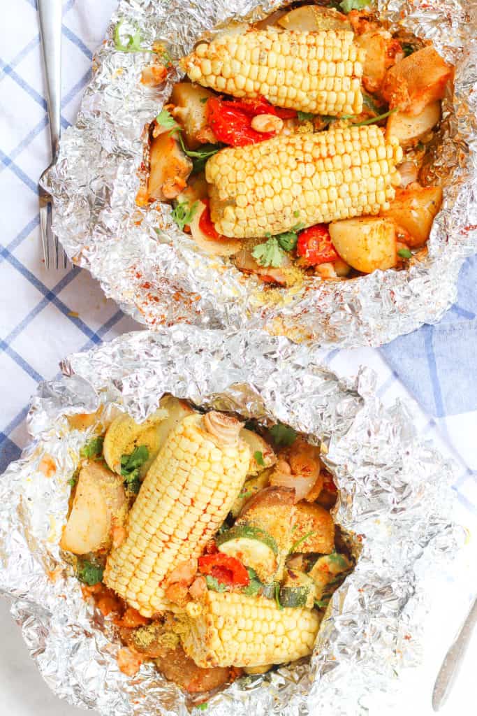 Foil packs are the easiest way to get your vegetables and plant-based protein while camping! Made with potatoes, corn, white beans, garlic, and paprika.