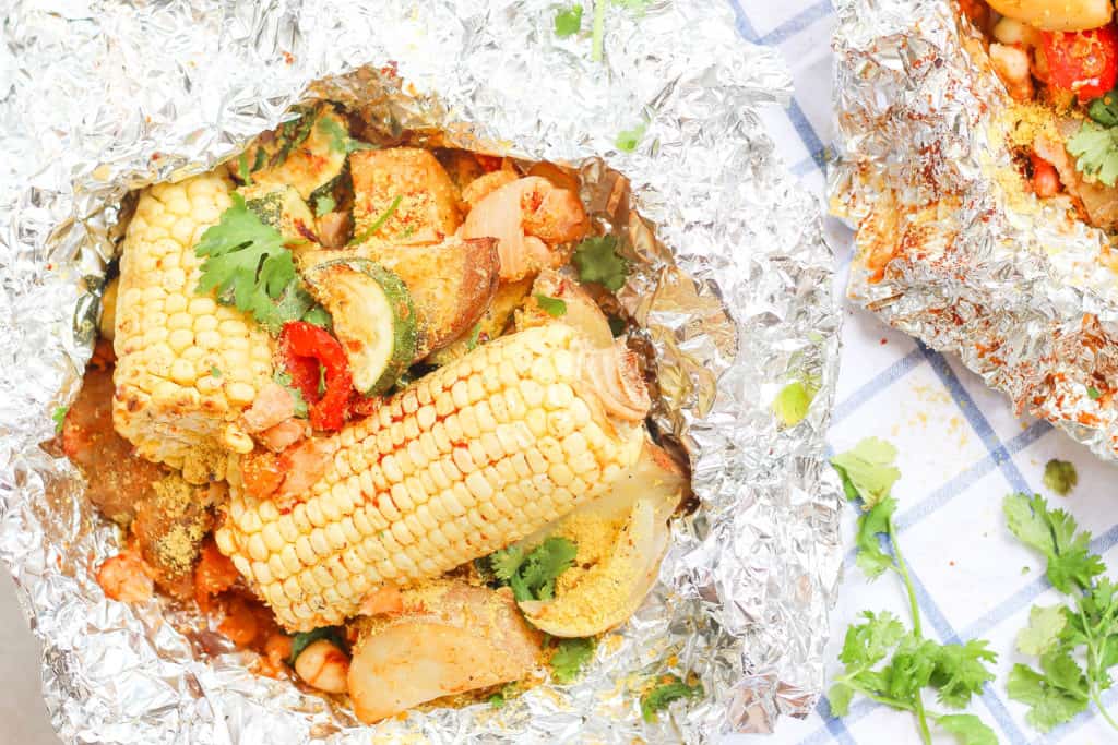 Foil packs are the easiest way to get your vegetables and plant-based protein while camping! Made with potatoes, corn, white beans, garlic, and paprika.