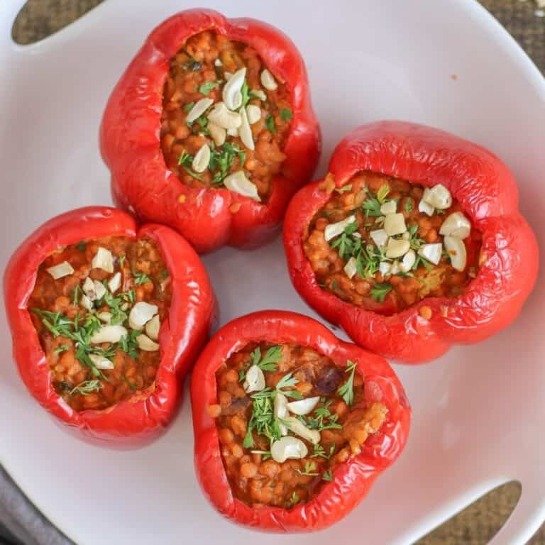 Red bell peppers stuffed with lentil coconut curry.