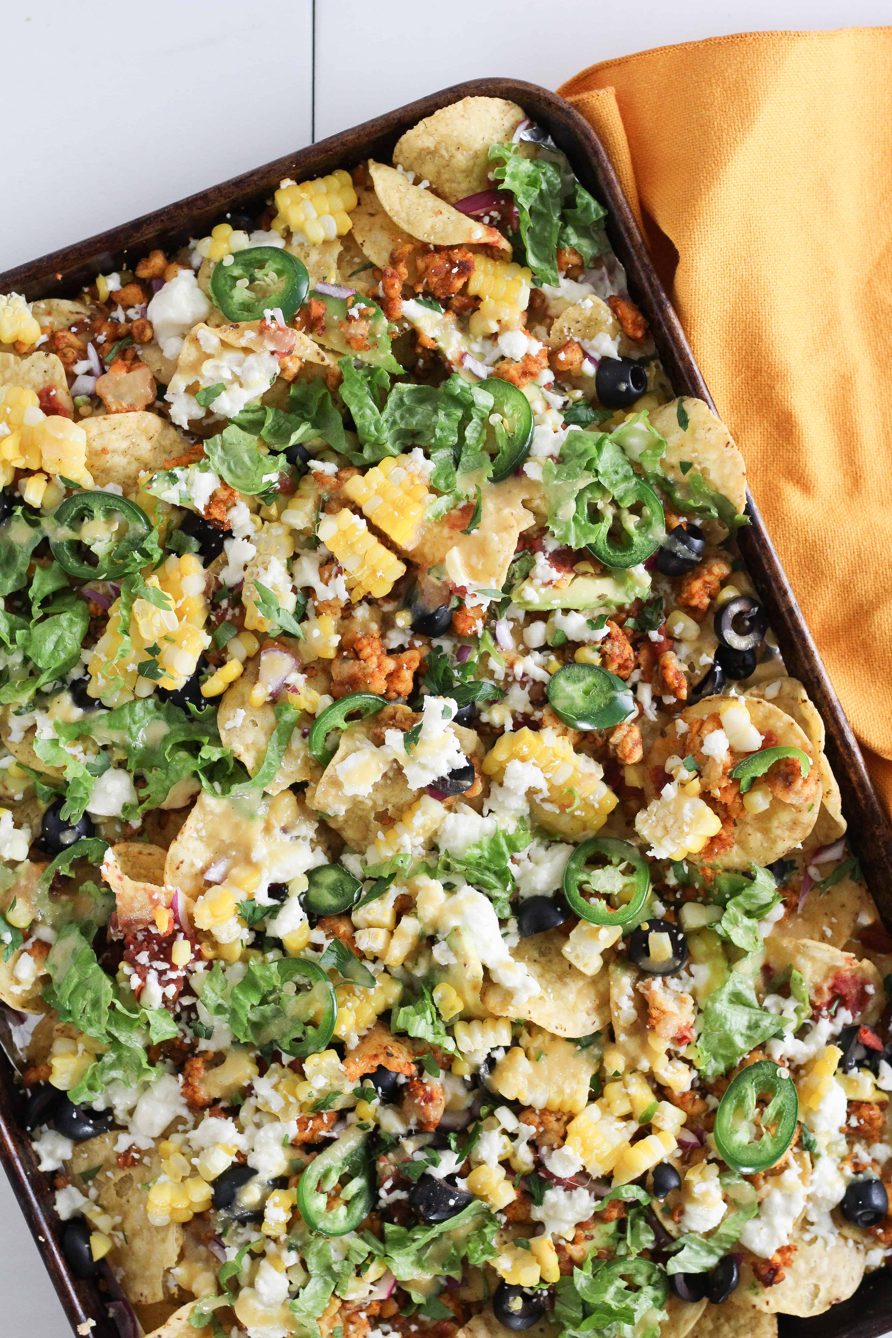Whether it’s a busy weeknight or a Sunday afternoon tailgate, this recipe for Easy Vegetarian Tempeh Sheet Pan Nachos is quick and easy perfection.