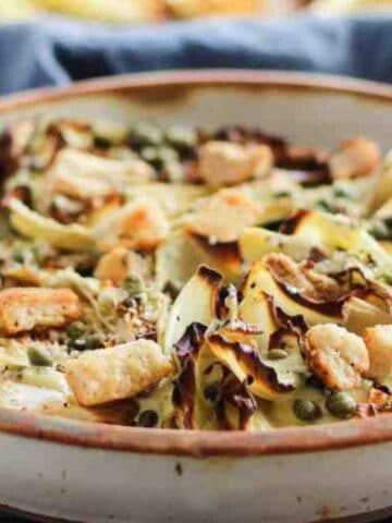 Warm roasted cabbage salad with croutons and vegan Caesar dressing.