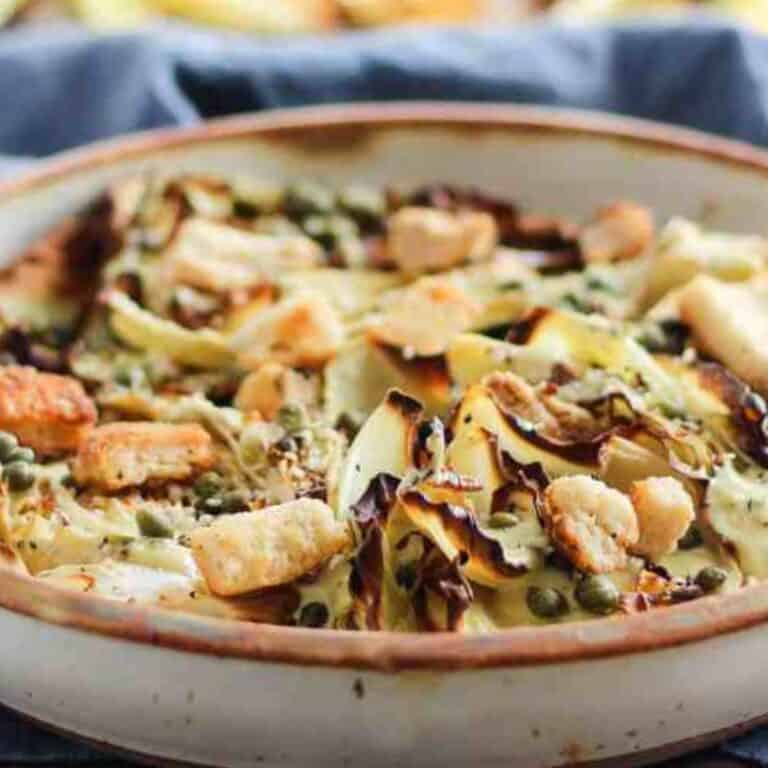 Warm roasted cabbage salad with croutons and vegan Caesar dressing.