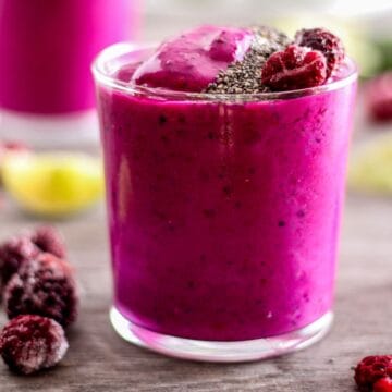 Vibrant pink dragon fruit smoothie with berries and chia seeds.