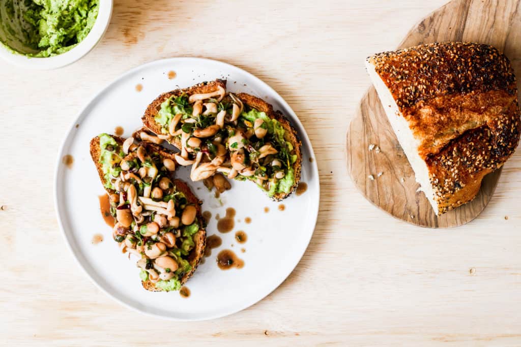 Mushroom avocado toast. A delicious recipe for savory breakfast lovers who don't like eggs. Topped with white beans for extra plant-based protein!