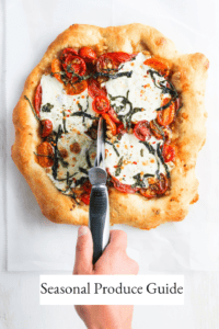 Tomato pizza being cut with pizza cutter and title text that reads, "Seasonal Produce Guide."