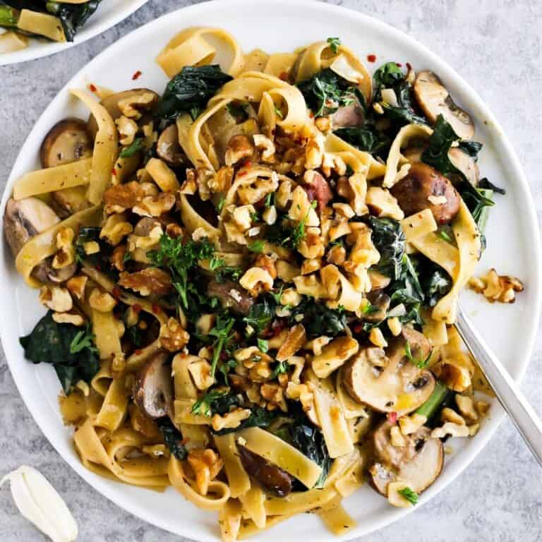 Creamy vegan pasta with mushrooms and kale.
