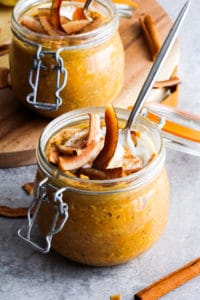 Coconut Cream Pumpkin Overnight Oats in mason jar with toasted coconut slices on top.