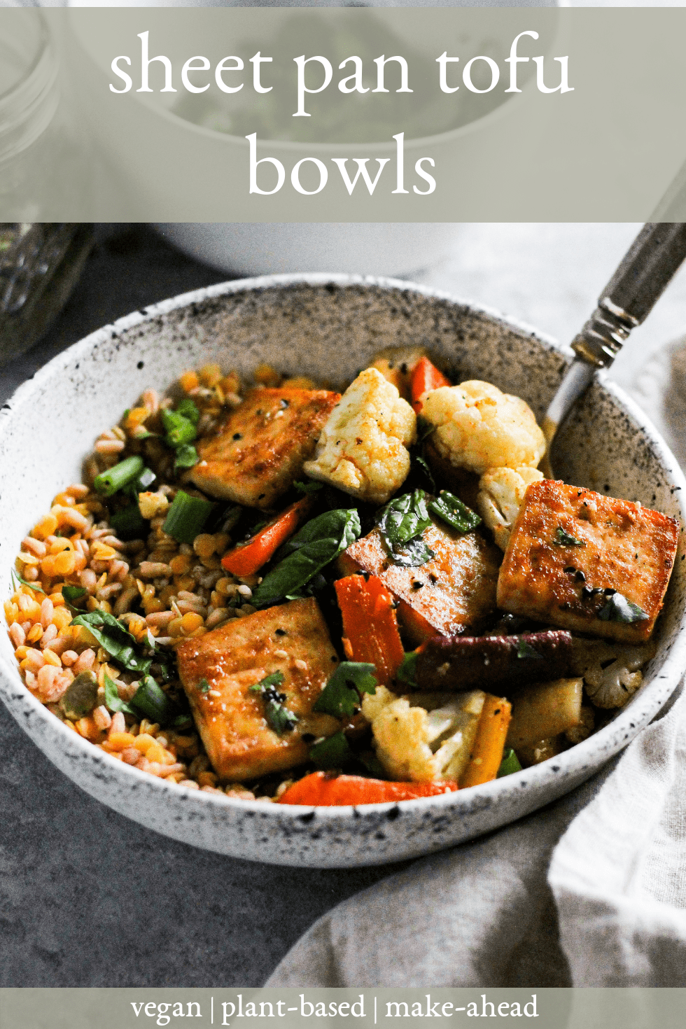 Sheet pan tofu bowls in white stone bowl with fork and white text that reads, "sheet pan tofu bowls."