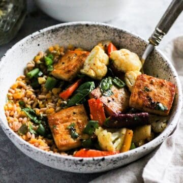 Tofu and lentils grain bowl with carrots and cauliflower.