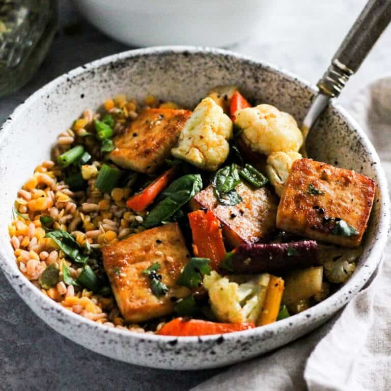 Tofu and lentils grain bowl with carrots and cauliflower.