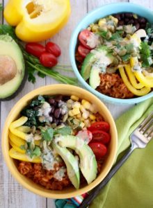 Bowl recipes. Yellow and blue bowls filled with Tomato Chipotle Rice Bowl with avocado and pepper.
