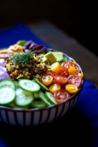 Bowl recipes. Mediterranean bowl with tomato and cucumber with dark background.