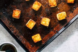 Horizontal image of crispy tofu on sheet pan.