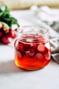 Jar filled with pickled radishes as a food waste solution.