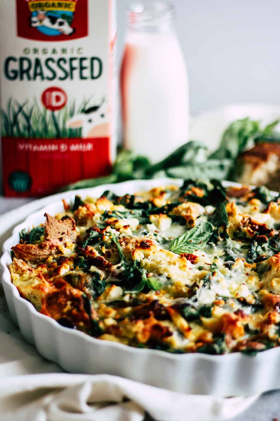 Strata in white dish with Horizon Organic milk carton in the background.