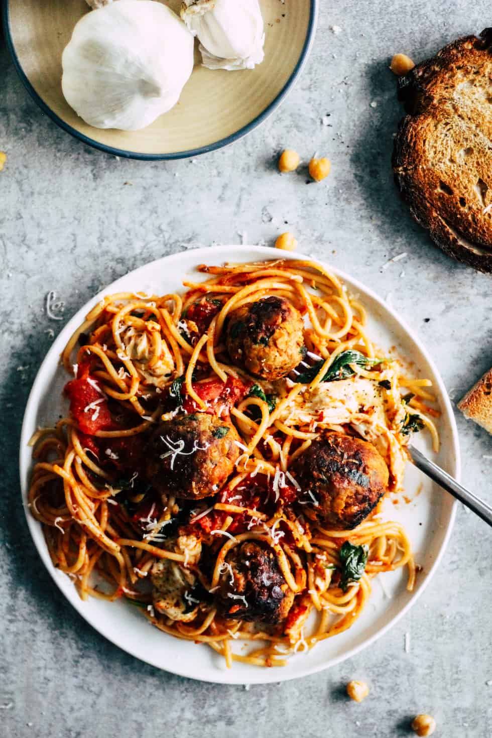 White plate of spaghetti with meatballs.