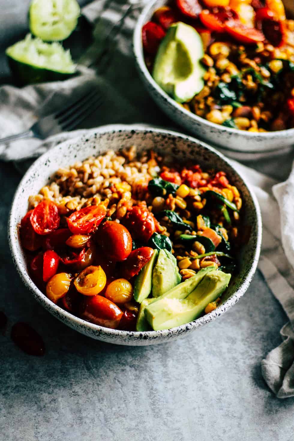 Tempeh burrito bowls in white ceramic dish with linen napkin.