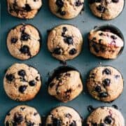 Whole wheat blueberry muffins with lemon and flax in a muffin tin.