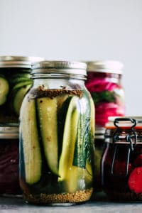 Quick pickles in mason jars with white background.