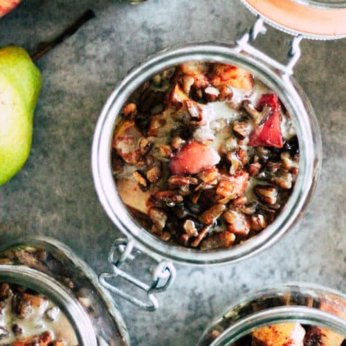 Mason jars filled with overnight oats and roasted apples and pears.