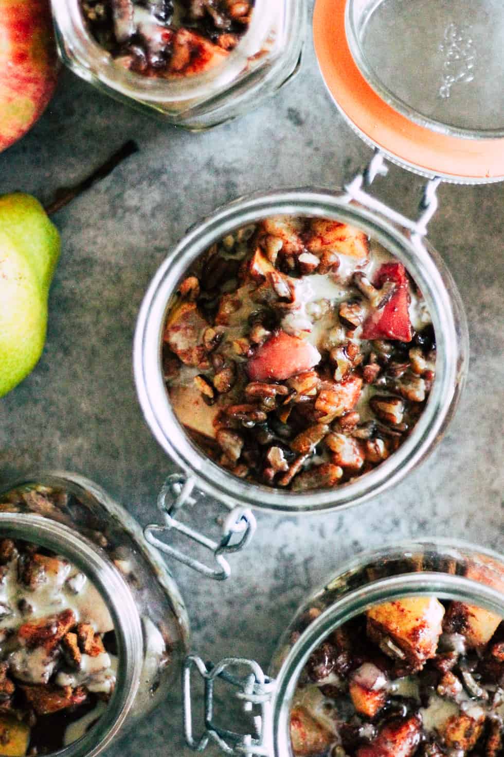 Mason jars filled with overnight oats and roasted apples and pears.