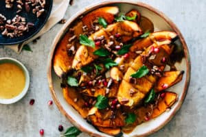 Roasted squash in dish with yellow curry sauce.