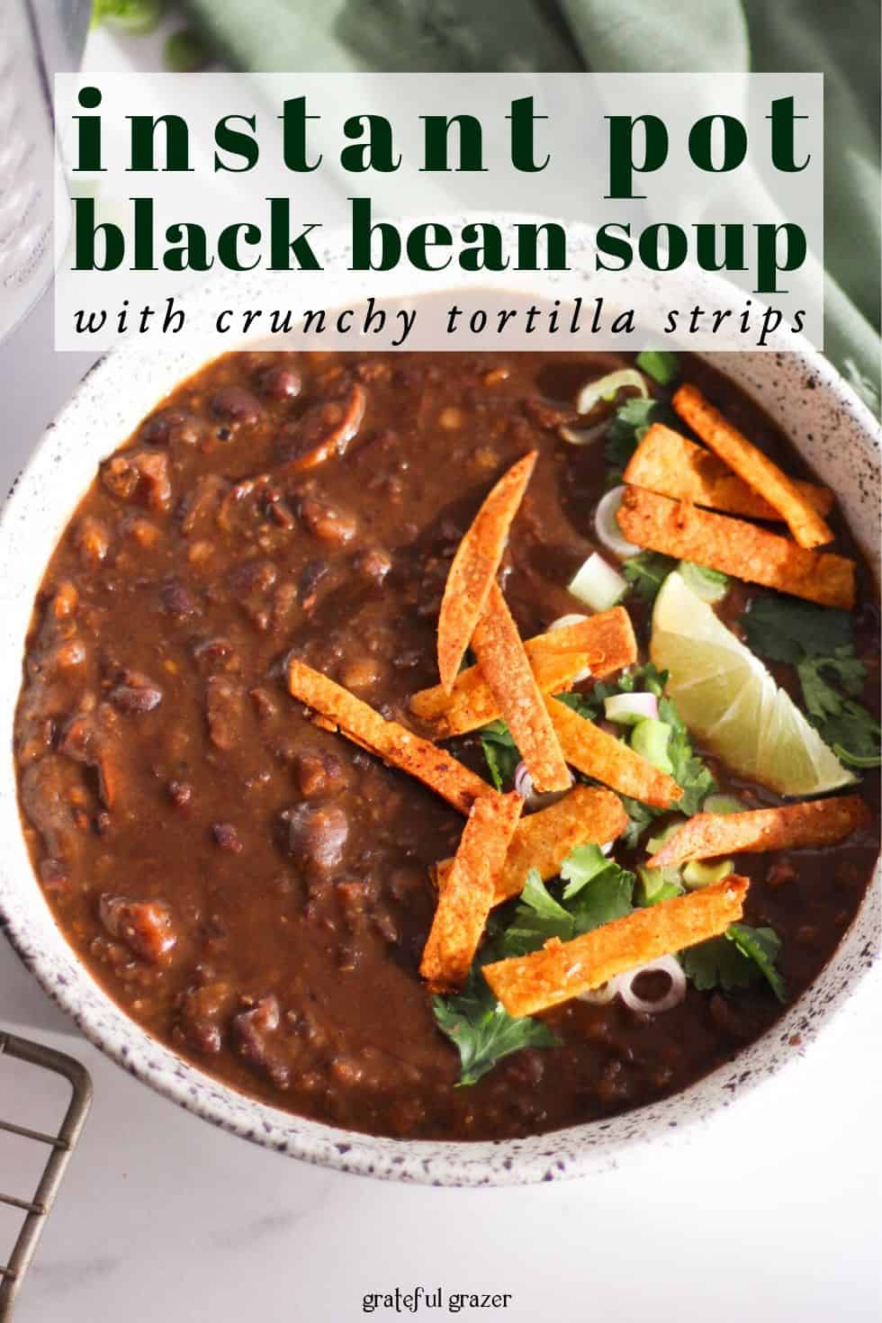 Bean soup in white bowl with text that reads, "instant pot black bean soup with crispy tortilla strips."