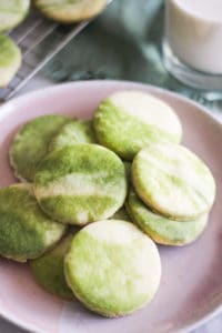 Marbled matcha sugar cookies on a pink plate.