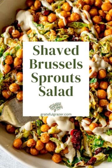 Closeup of a salad with chickpeas and creamy tahini dressing. Text overlay reads, "Shaved Brussels Sprouts Salad."