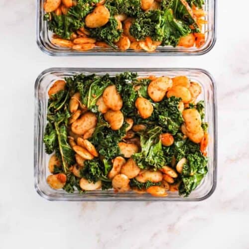 Square image of butter beans and greens in a meal prep container.