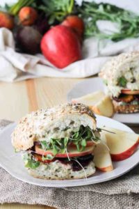 Roasted Apple and Beet Sandwiches on white plates as examples of vegetarian lunches to pack for work or school.