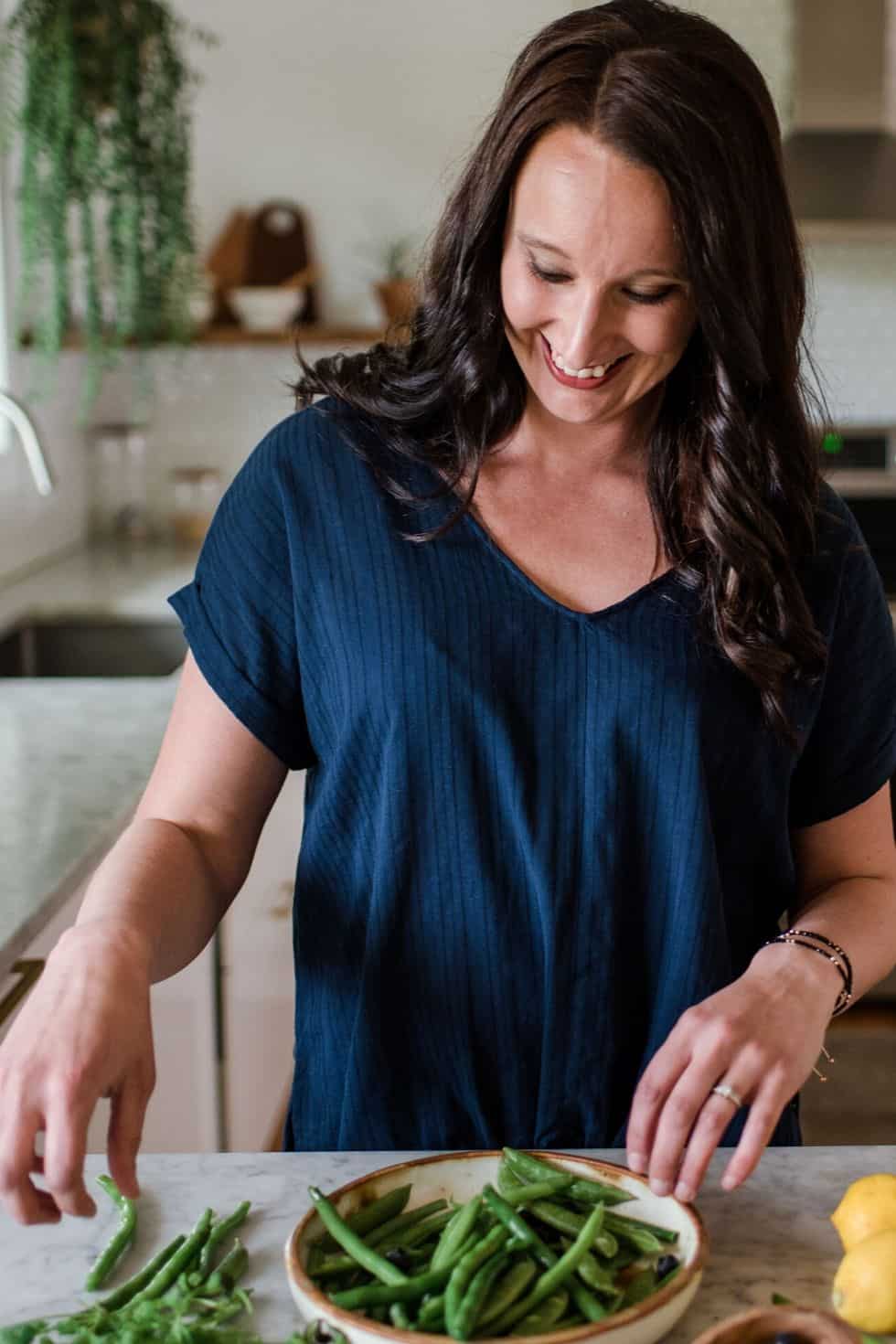 Stephanie McKercher cooking in kitchen.