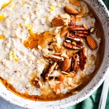 Creamy lemon oatmeal with nuts and maple syrup for toppings.